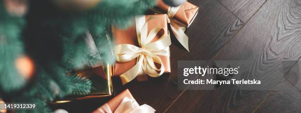 gifts under the christmas tree on the floor. gift wrapping. surprise. new year. christmas. - below stock pictures, royalty-free photos & images