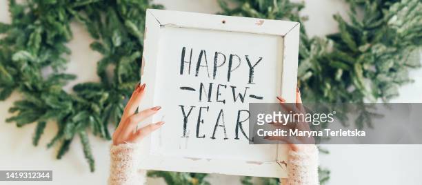a plate in the hands with the inscription happy new year. christmas. new year. winter holidays. - happy new month stockfoto's en -beelden