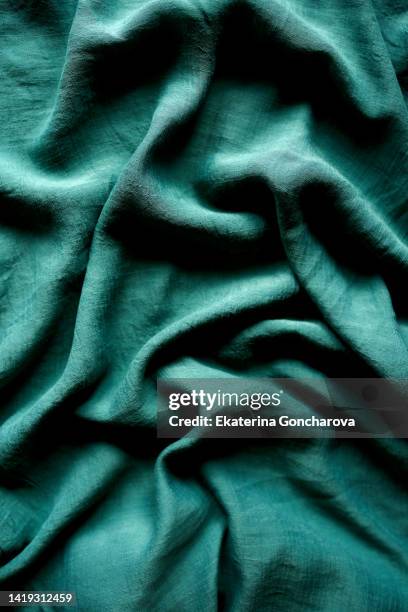 green fabric with pleats. abstract textile background - green curtain stock pictures, royalty-free photos & images