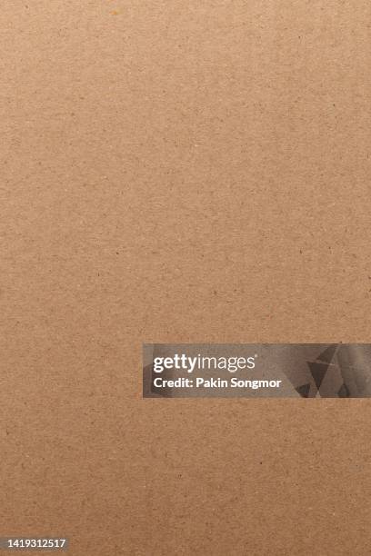 brown color eco recycled kraft paper sheet texture cardboard background. - kraft paper stockfoto's en -beelden