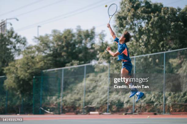 asian chinese male professional tennis player jumping mid air serving in hardcourt - hardcourt 個照片及圖片檔