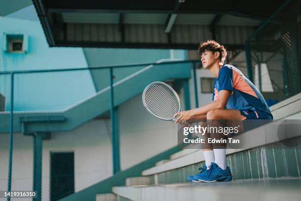asian chinese professional male tennis player sitting in stadium tennis court in the morning - bleachers stock pictures, royalty-free photos & images