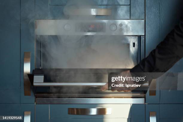 blue kitchen with a oven with burnt food - dirty oven stock pictures, royalty-free photos & images