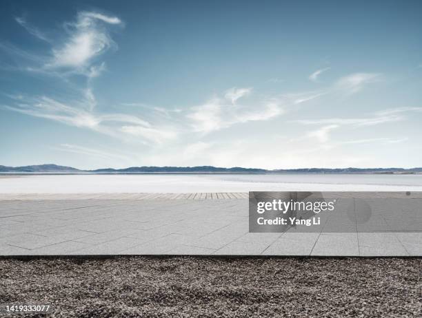 low and wide angle view of square parking lot nearby the saline - horizon over land road stock pictures, royalty-free photos & images