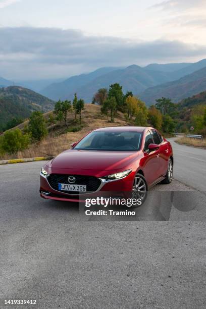 mazda3 sedan on a road - carro tipo sallon imagens e fotografias de stock