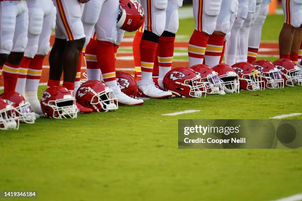 Kansas City Chiefs helmets line the ground as players lock arms during a moment of unity before an NFL game against the Houston Texans, Sunday, Sep....