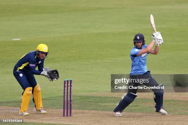 Ollie Robinson of Kent hits out while Hampshire's Ben Brown looks on during the Royal London Cup Semi Final between Hampshire and Kent Spitfires at...