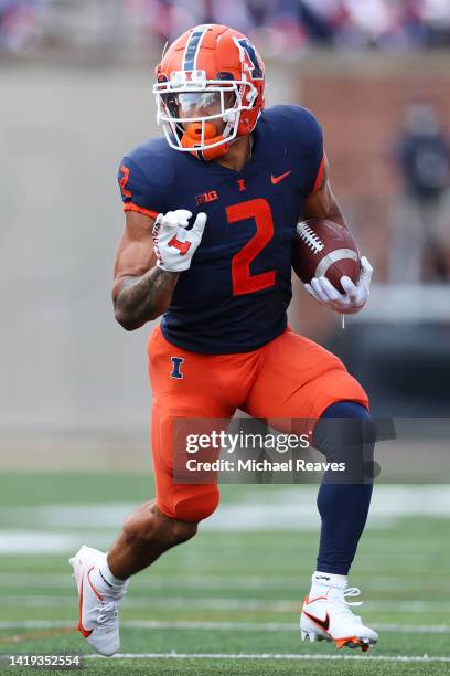 Chase Brown of the Illinois Fighting Illini runs with the ball against the Wyoming Cowboys during the first half at Memorial Stadium on August 27,...