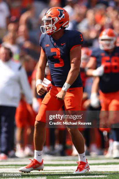 Tommy DeVito of the Illinois Fighting Illini celebrates after throwing a touchdown pass to Chase Brown against the Wyoming Cowboys during the first...