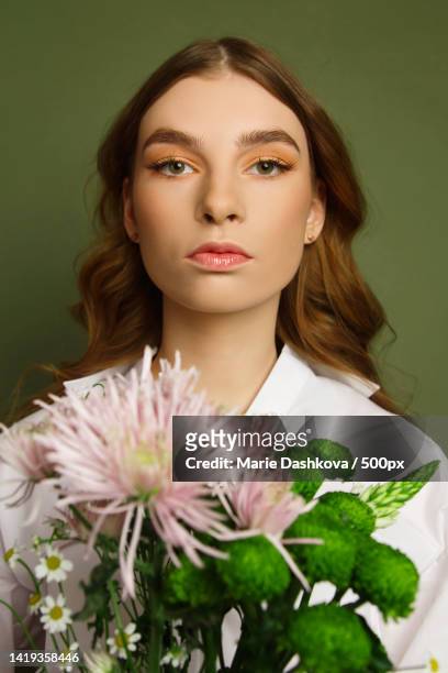 beautiful young woman with flowers - editorial style stock pictures, royalty-free photos & images