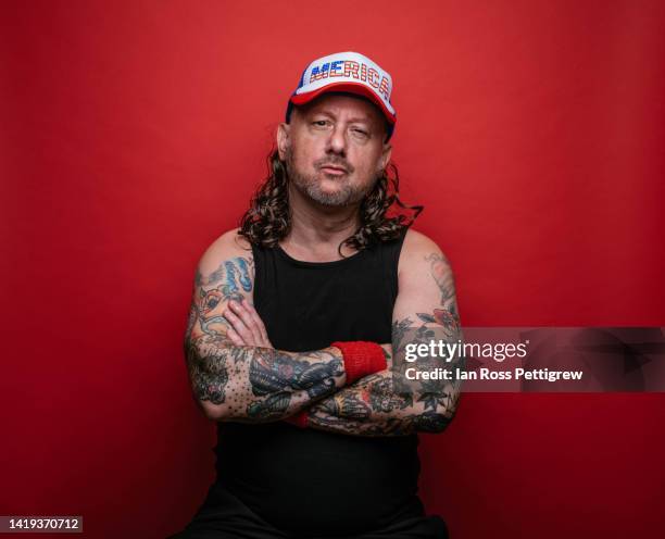 redneck man with tattoos and mullet wearing "merica" hat - hillbilly stock pictures, royalty-free photos & images