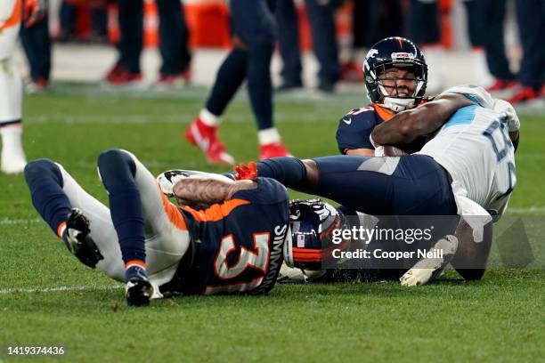 Denver Broncos cornerback Bryce Callahan brings Corey Davis of the Tennessee Titans to the ground during an NFL game against the Tennessee Titans,...