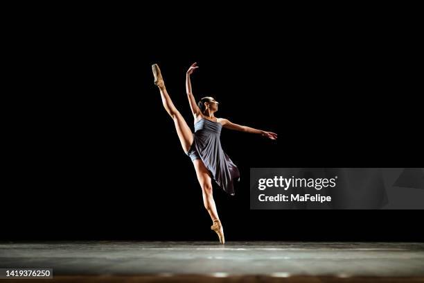 girl dancing neoclassic ballet on dark stage - ballet stock pictures, royalty-free photos & images