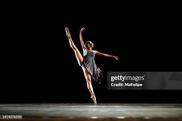 girl dancing neoclassic ballet on dark stage - ballet dancing stock pictures, royalty-free photos & images