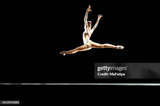 girl performing contemporary dance on dark stage - dance competition stock pictures, royalty-free photos & images