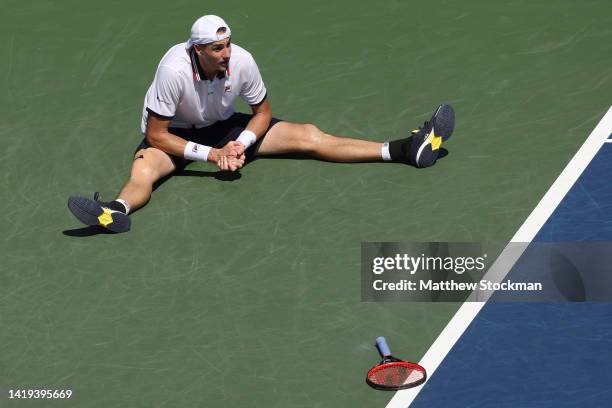 John Isner of the United States reacts against Federico Delbonis of Argentina in their Men's Singles First Round match on Day Two of the 2022 US Open...
