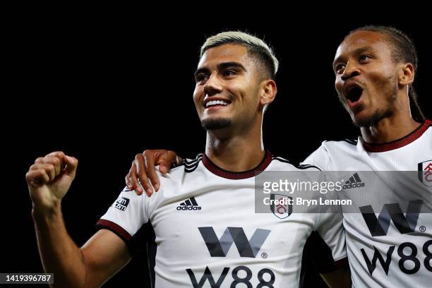 Andreas Pereira of Fulham celebrates with teammate Neeskens Kebano after their team's second goal, an own goal scored by Lewis Dunk of Brighton &...
