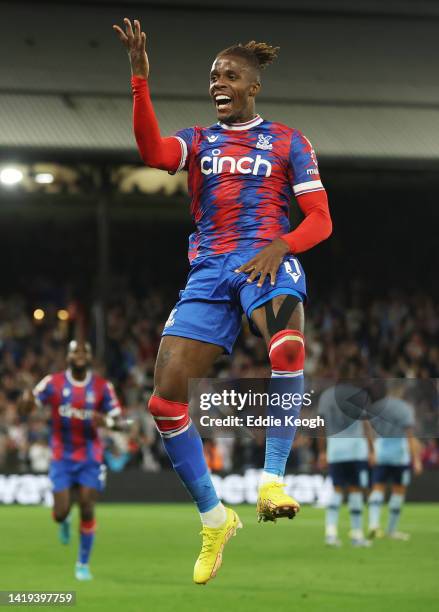 Wilfried Zaha of Crystal Palace celebrates after scoring their team's first goal during the Premier League match between Crystal Palace and Brentford...