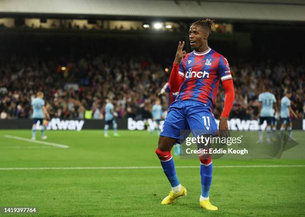 Wilfried Zaha of Crystal Palace celebrates after scoring their team's first goal during the Premier League match between Crystal Palace and Brentford...