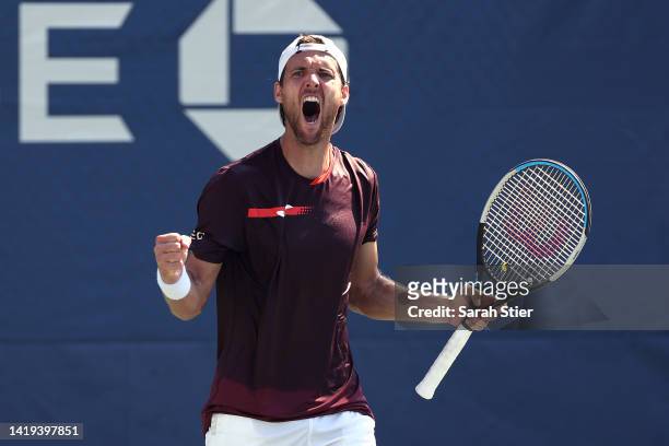 Joao Sousa of Portugal celebrates after defeating Mackenzie McDonald of the United States in their Men's Singles First Round match on Day Two of the...
