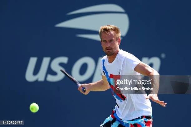 Peter Gojowczyk of Germany returns a shot against Holger Rune of Denmark in their Men's Singles First Round match on Day Two of the 2022 US Open at...