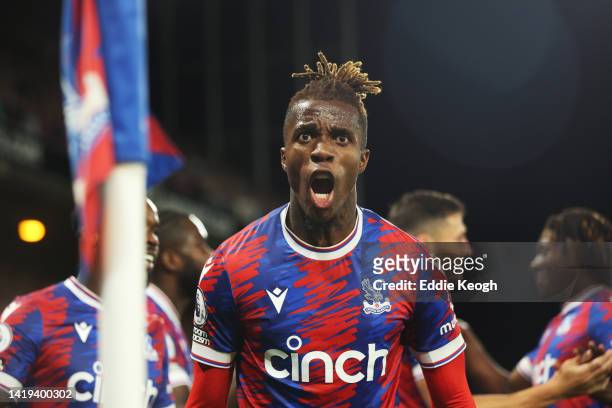 Wilfried Zaha of Crystal Palace celebrates after scoring their team's first goal during the Premier League match between Crystal Palace and Brentford...