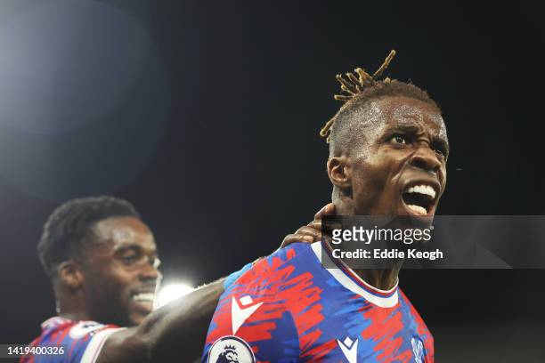 Wilfried Zaha of Crystal Palace celebrates after scoring their team's first goal during the Premier League match between Crystal Palace and Brentford...