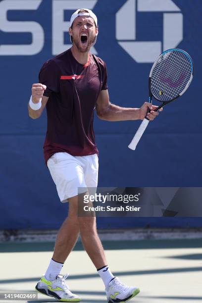 Joao Sousa of Portugal celebrates after defeating Mackenzie McDonald of the United States in their Men's Singles First Round match on Day Two of the...
