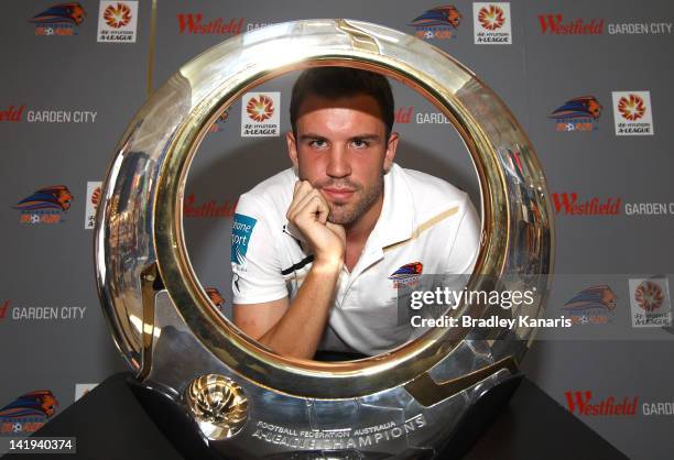 Matthew Jurman poses with the A-League winners trophy during the Brisbane Roar A-League Finals Series launch at Sony Store on March 27, 2012 in...