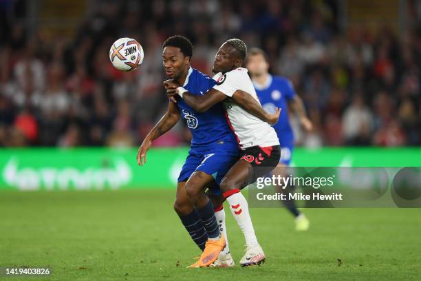 Raheem Sterling of Chelsea is challenged by Moussa Djenepo of Southampton during the Premier League match between Southampton FC and Chelsea FC at...