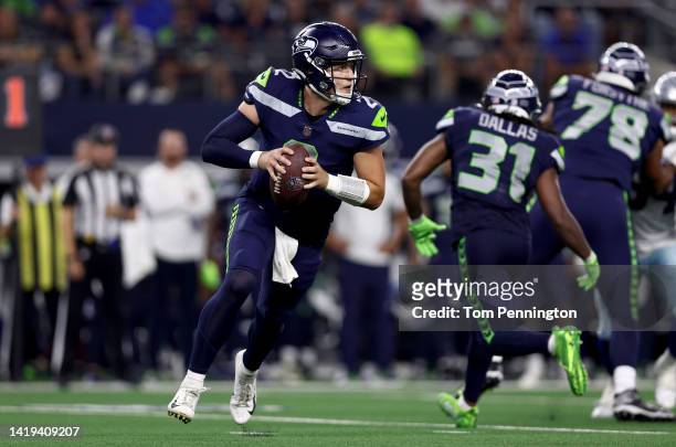 Quarterback Drew Lock of the Seattle Seahawks looks for an open receiver against the Dallas Cowboys in the fourth quarter of a NFL preseason football...