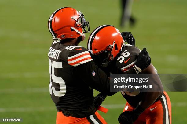 Myles Garrett of the Cleveland Browns and outside linebacker Malcolm Smith celebrate during an NFL game against the Cincinnati Bengals, Thursday,...