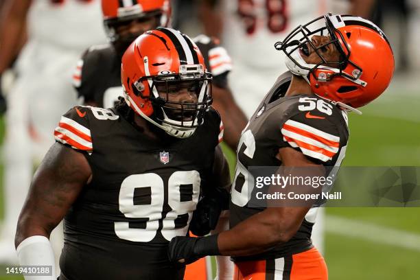 Malcolm Smith of the Cleveland Browns celebrates with defensive tackle Sheldon Richardson during an NFL game against the Cincinnati Bengals,...