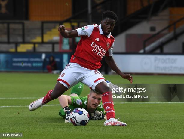 Nathan Butler-Oyedeji scores Arsenal's 1st goal under pressure from Will Mannion of Cambridge during the Papa John's match between cambridge United...