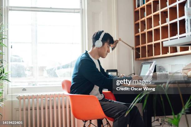 young asian man studying online with laptop - e learning asian stock pictures, royalty-free photos & images