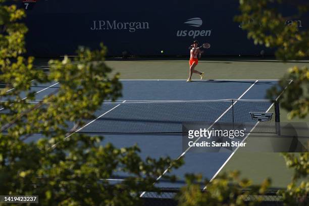 Andrea Petkovic of Germany returns a shot against Belinda Bencic of Switzerland in their Women's Singles First Round match on Day Two of the 2022 US...