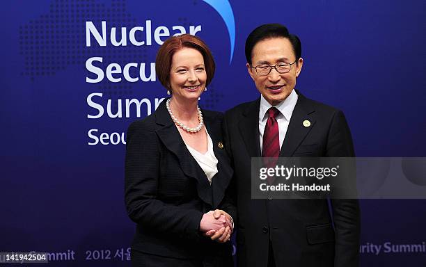 In this handout image provided by Yonhap News, Australian Prime Minister Julia Gillard and South Korean President Lee Myung-bak pose for photogrpahs...