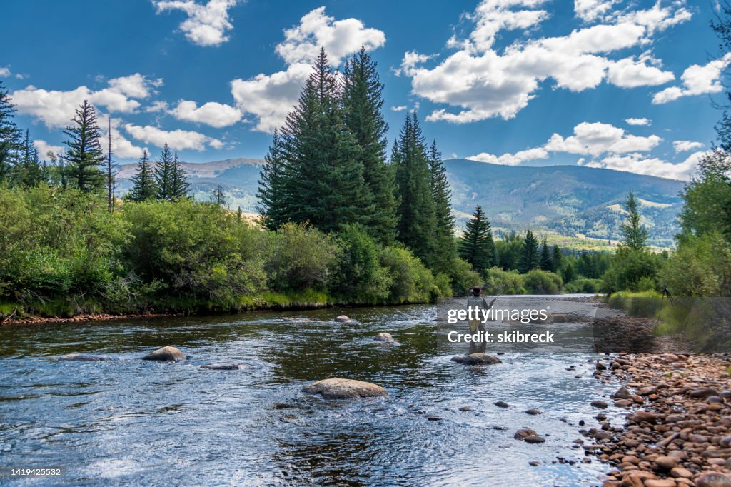 Senior Woman Fly-Fishing in the Blue River of Colorado