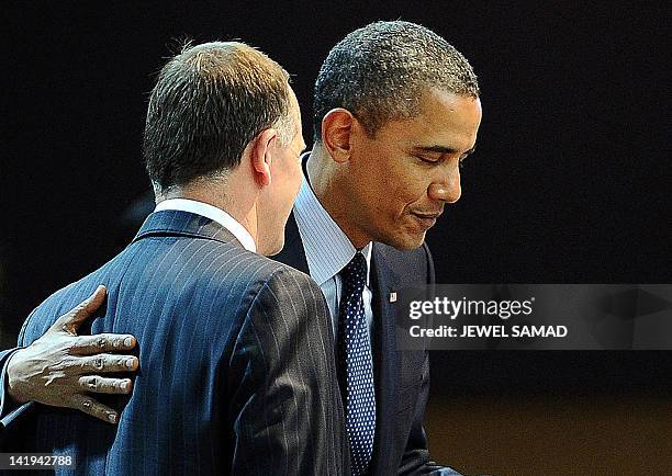 President Barack Obama chats to New Zealand Prime Minister John Key before the start of a second plenary session of the 2012 Nuclear Security Summit...