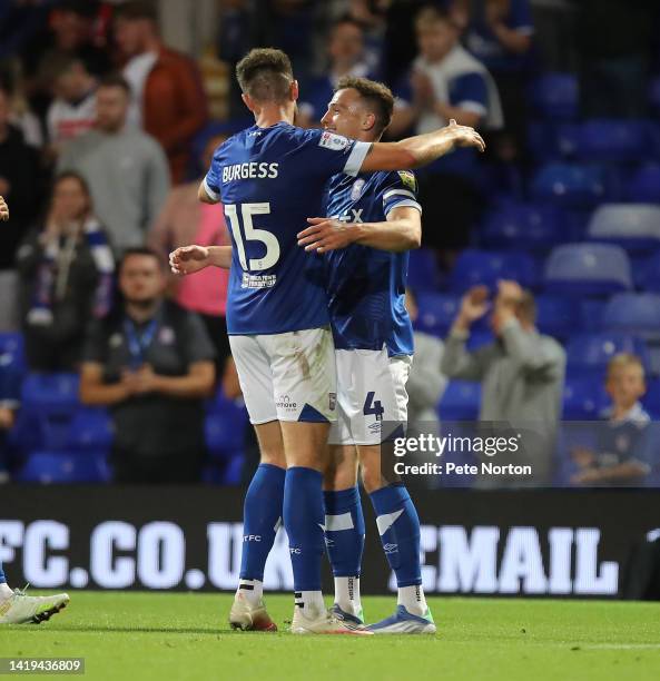 George Edmundson of Ipswich Town is congratulated by Cameron Burgess after scoring his sides 6th goal during the Papa John's Trophy match between...