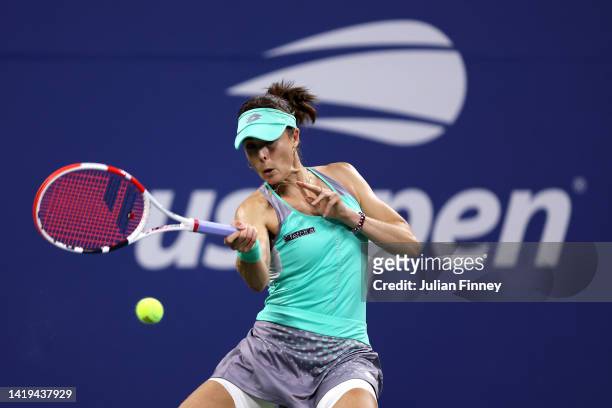 Alize Cornet of France returns a shot against Emma Raducanu of Great Britain in their Women's Singles First Round match on Day Two of the 2022 US...