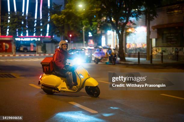 food delivery drivers are driving to deliver products to customers who order online. - night delivery stock pictures, royalty-free photos & images