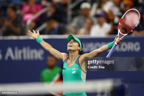 Alize Cornet of France celebrates after defeating Emma Raducanu of Great Britain in their Women's Singles First Round match on Day Two of the 2022 US...