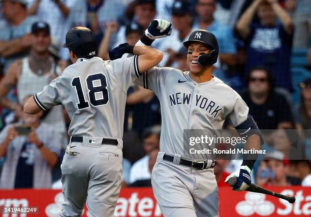 Andrew Benintendi of the New York Yankees celebrates a home run with Aaron Judge in the first inning against the Los Angeles Angels at Angel Stadium...