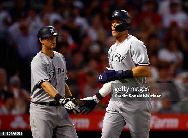 Aaron Judge of the New York Yankees celebrates a run with DJ LeMahieu against the Los Angeles Angels in the third inning at Angel Stadium of Anaheim...