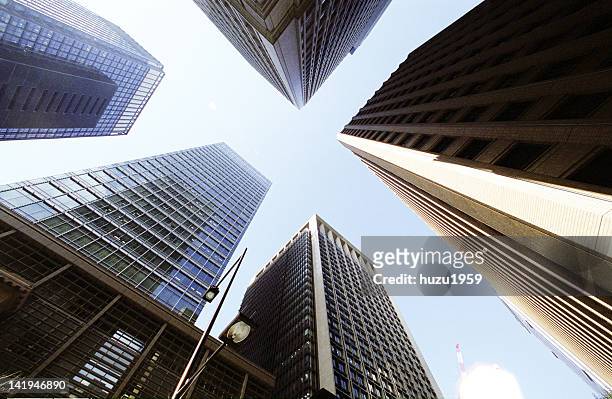 upward view of tokyo skyscrapers - marunouchi stock-fotos und bilder