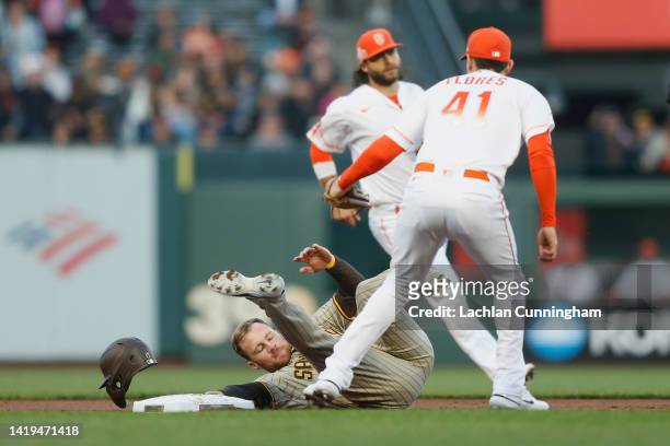 Brandon Drury of the San Diego Padres is tagged out on a steal attempt at second base by Wilmer Flores of the San Francisco Giants in the top of the...