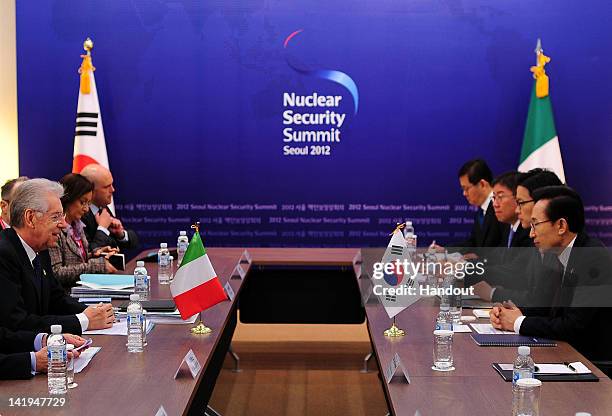 In this handout image provided by Yonhap News, Italian Prime Minister Mario Monti and South Korean President Lee Myung-bak talk during their...