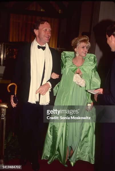 Accompanied by an unidentified man, socialite Ivana Trump attends an event at the Waldorf Astoria Hotel, New York, New York, May 1990.