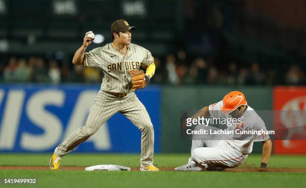Ha-Seong Kim of the San Diego Padres gets the out on LaMonte Wade Jr. #31 of the San Francisco Giants at second base in the bottom of the seventh...
